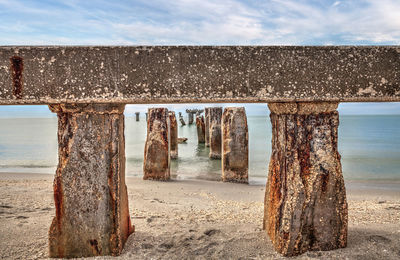 View of old built structure at beach against sea