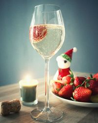 Close-up of wine with strawberries on table