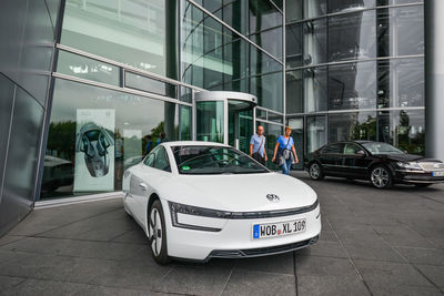 View of car on glass window of building