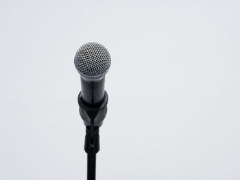 Low angle view of microphone against white background