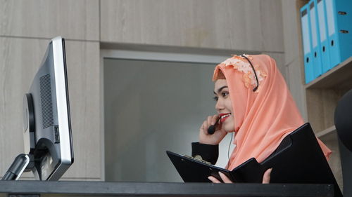 Side view of woman using laptop