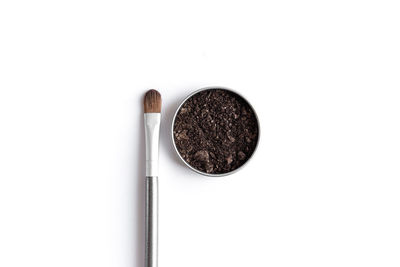 High angle view of coffee cup against white background