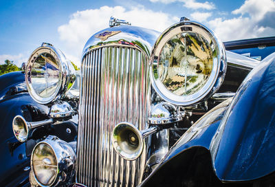 Close-up of bicycles against blue sky