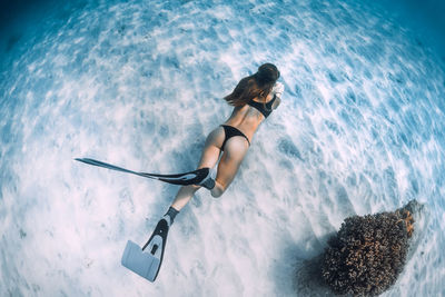 Low angle view of woman swimming in sea