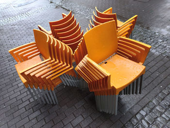 High angle view of orange chairs on table
