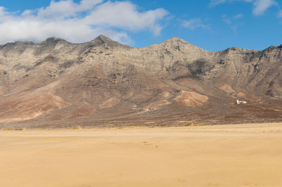 Scenic view of arid landscape against sky