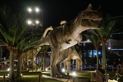 Statue of illuminated city at night