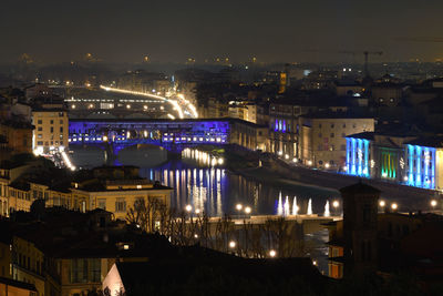 High angle view of illuminated buildings against sky at night