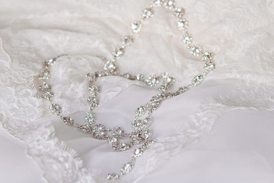 Close-up of necklace on wedding dress