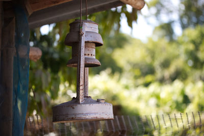 Close-up of rusty metal hanging on wood