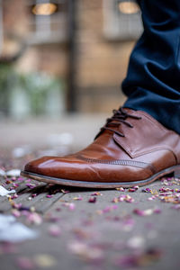 Low section of man standing on street