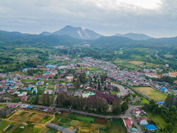 High angle view of townscape and mountains against sky
