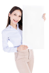 Portrait of a smiling young woman against white background
