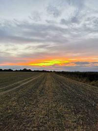 Scenic view of field against sky during sunset