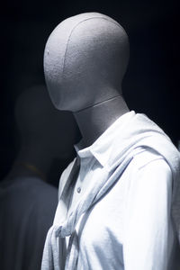 Mannequin wearing shirt in store at night
