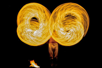 Close-up of illuminated lighting equipment against black background