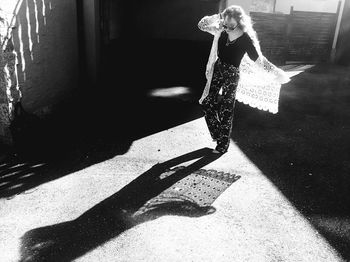 Shadow of woman standing on wall