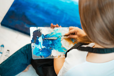 High angle view of woman sitting with blue eyes