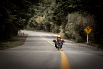 Man riding motorcycle on road