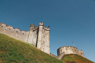 Low angle view of arundel castle against clear blue sky