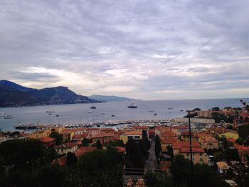 Scenic view of sea by city against sky