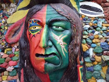 Portrait of man with multi colored umbrellas