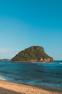 Scenic view of sea against clear blue sky