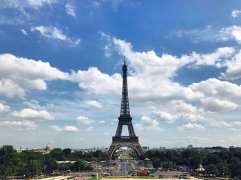 Eiffel tower in city against sky