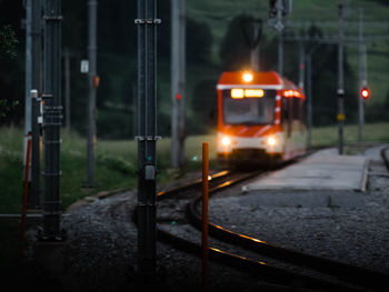 Train on illuminated street at night