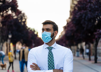 Portrait of young man standing on street