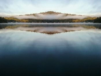 Scenic view of lake against cloudy sky