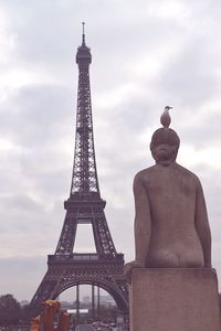 Statue of tower against cloudy sky