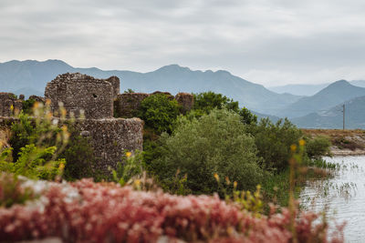 View of castle on mountain against cloudy sky