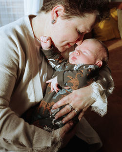 Grandmother kissing a newborn grandson