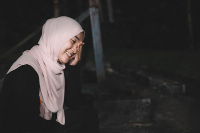 Portrait of smiling woman wearing hijab