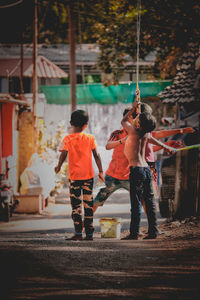 Rear view of people on street in city