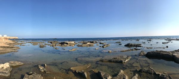 Scenic view of sea against clear blue sky