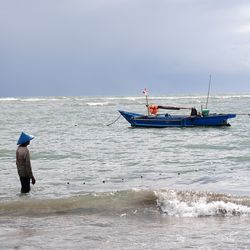 People on beach against sky