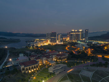 High angle view of city lit up at night