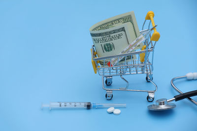 High angle view of medicines and stethoscope against white background