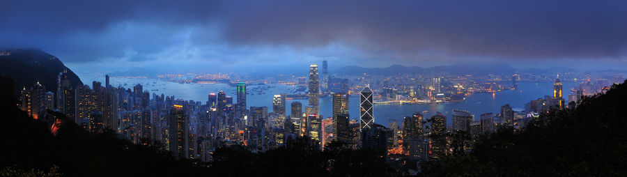 Panoramic view of illuminated buildings against sky at night