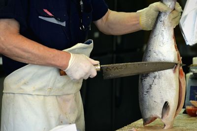 Person cutting fish