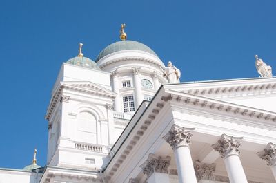 Low angle view of church against clear blue sky during sunny day