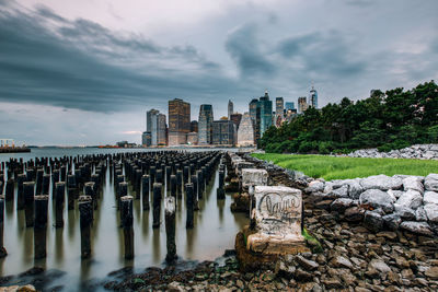 Panoramic shot of buildings by river against sky