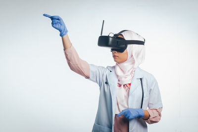 Full length of man photographing against white background