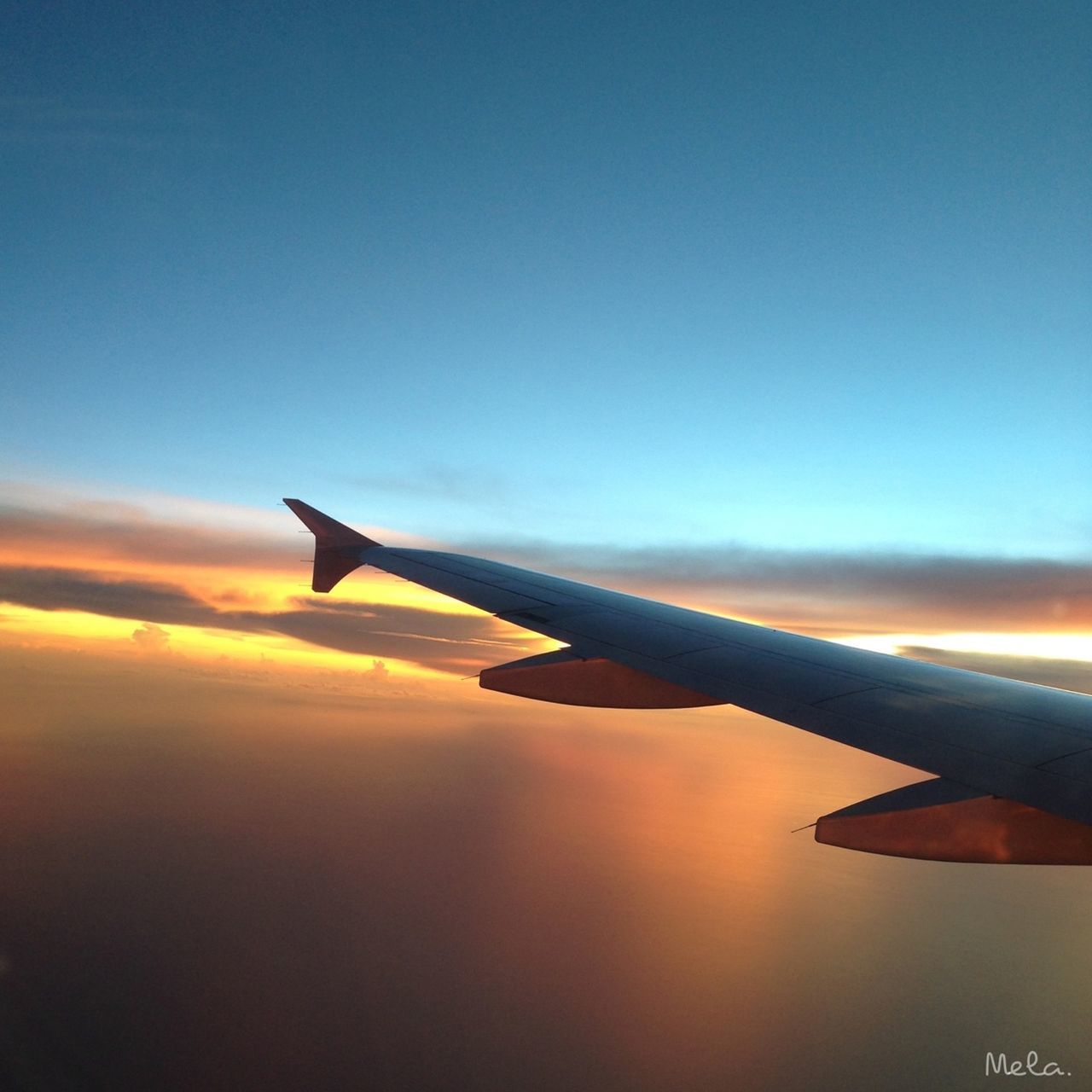 airplane, aircraft wing, air vehicle, flying, transportation, mode of transport, part of, aerial view, mid-air, sky, cropped, travel, public transportation, sunset, on the move, airplane wing, journey, scenics, blue, cloud - sky