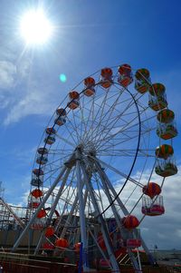 Low angle view of ferris wheel against sky