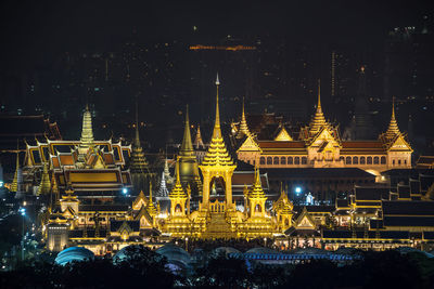 Illuminated temple building against sky at night