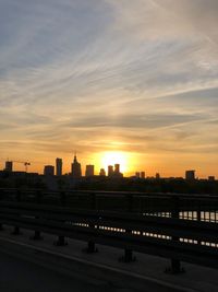 Buildings in city against sky during sunset