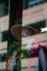 Mannequin in store through window